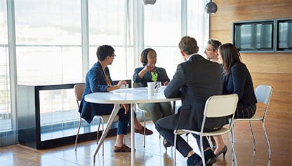 People sitting around office table